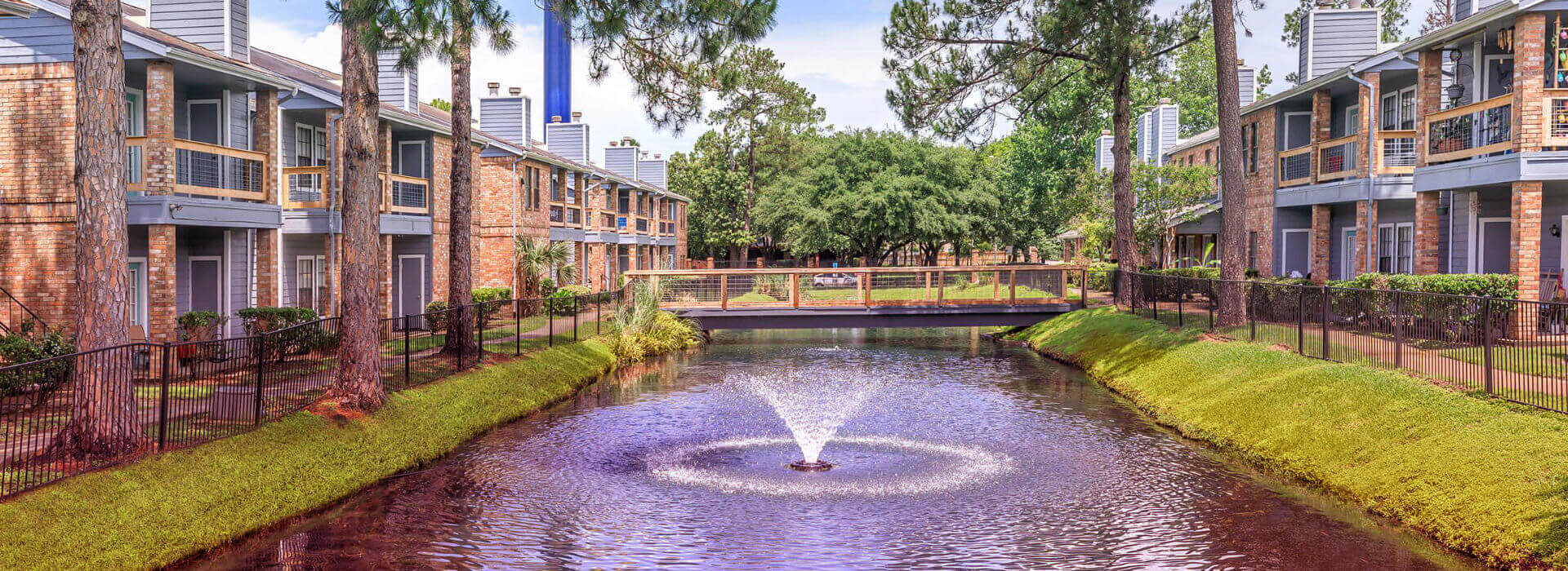 exterior area of a Q10 property with a water feature and a bridge