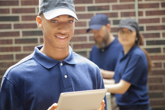 a man holding a tablet device