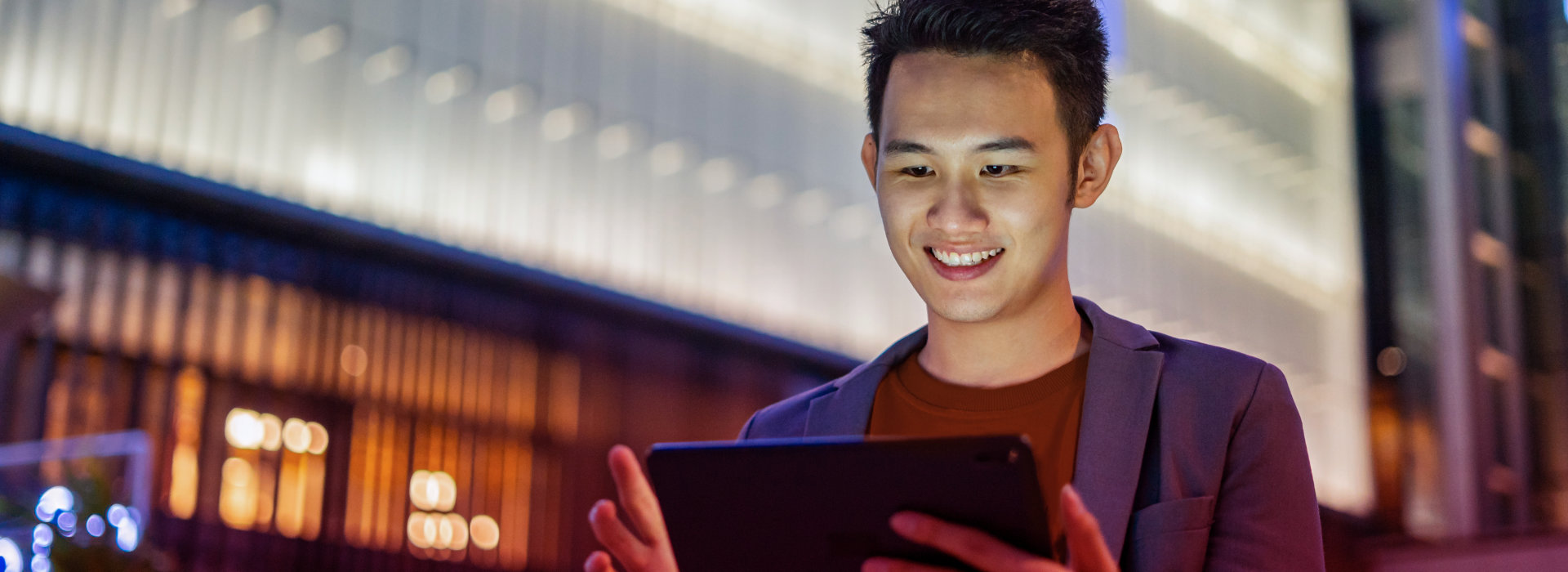 a man looking at a tablet device